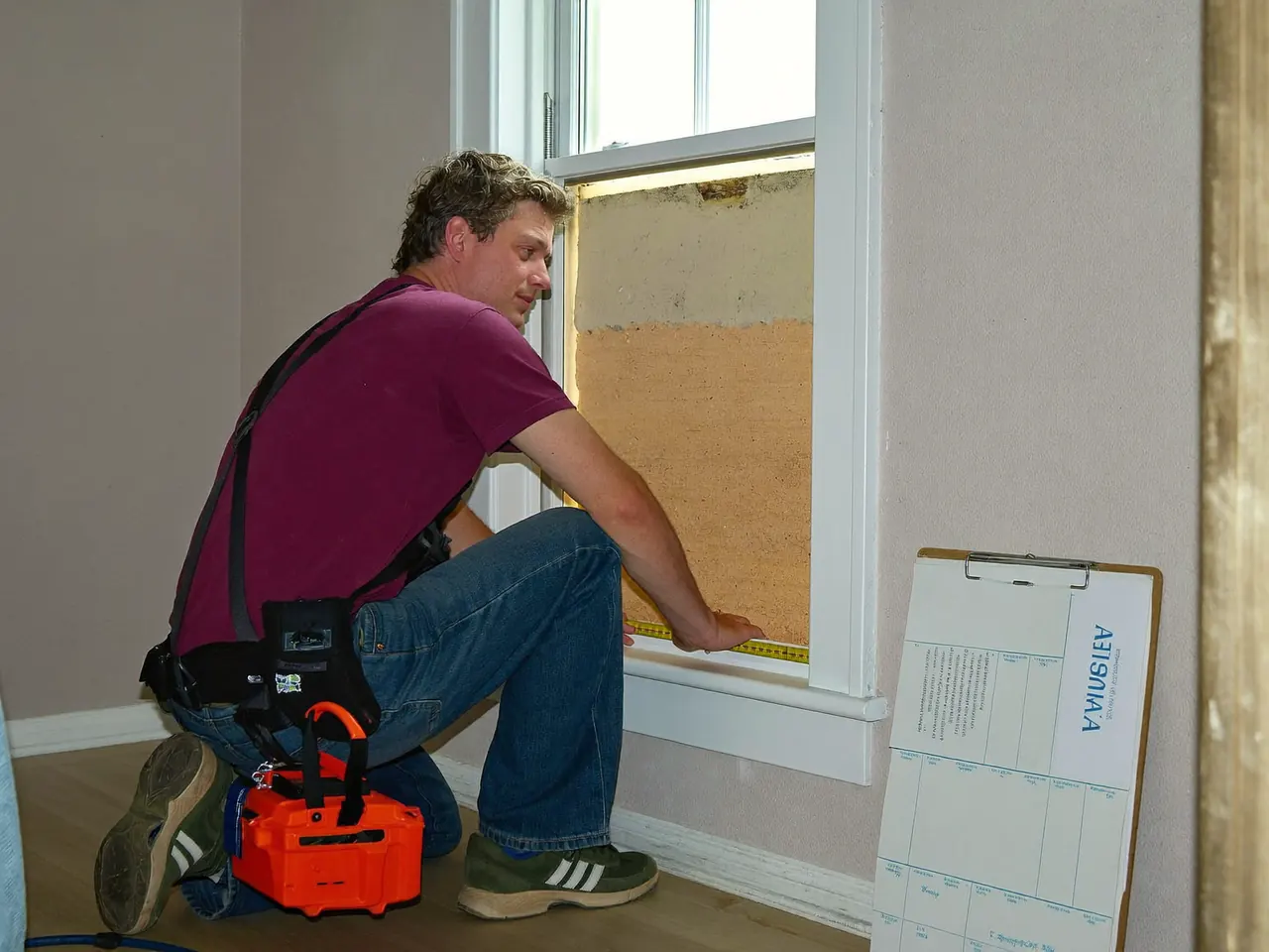 Installer measuring a window opening during a home survey